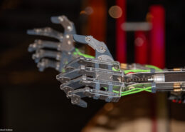 Mechanische Roboterhand mit mehreren beweglichen Fingern und elektrischen Komponenten.